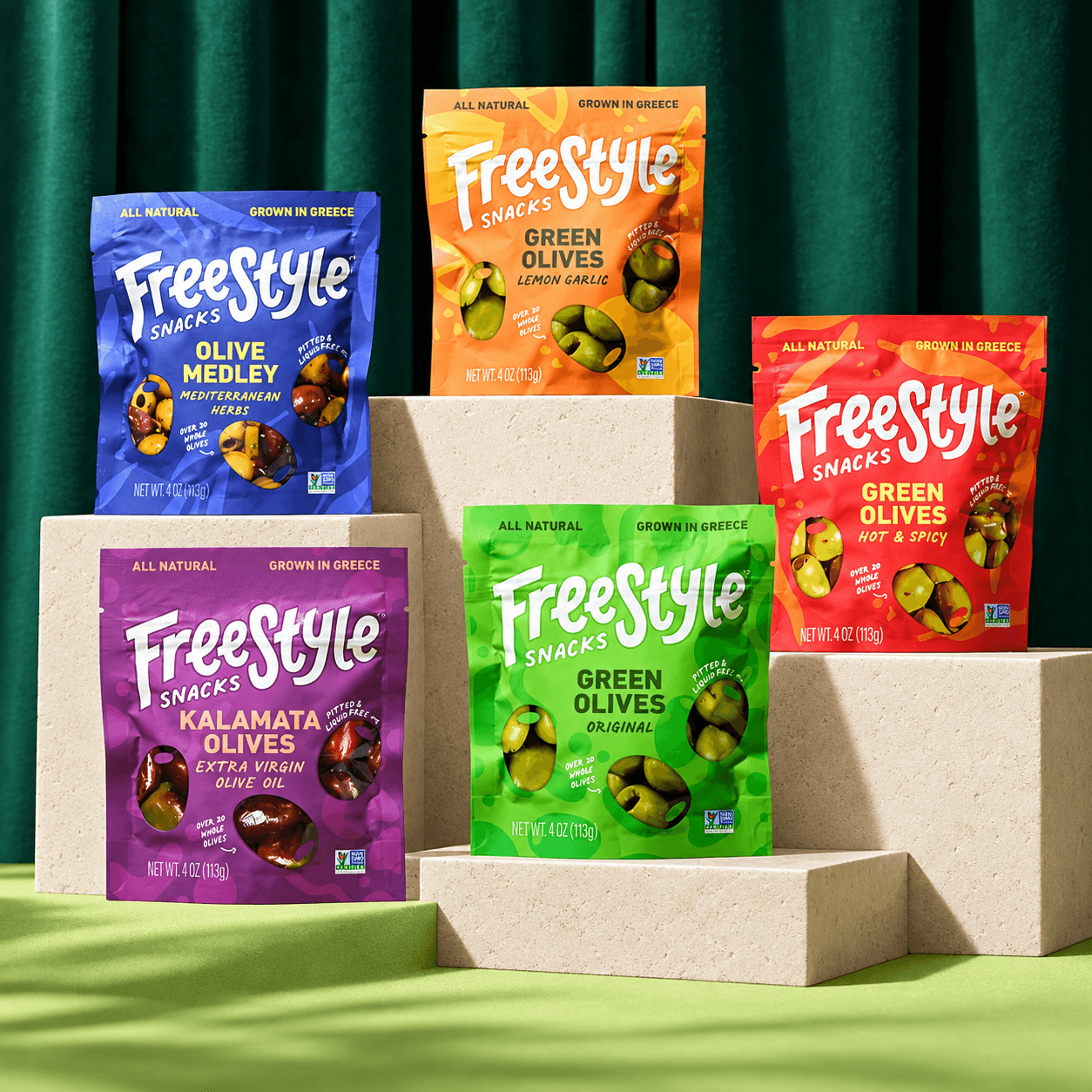An assortment of colorful Freestyle Snacks olive and pickle packages
