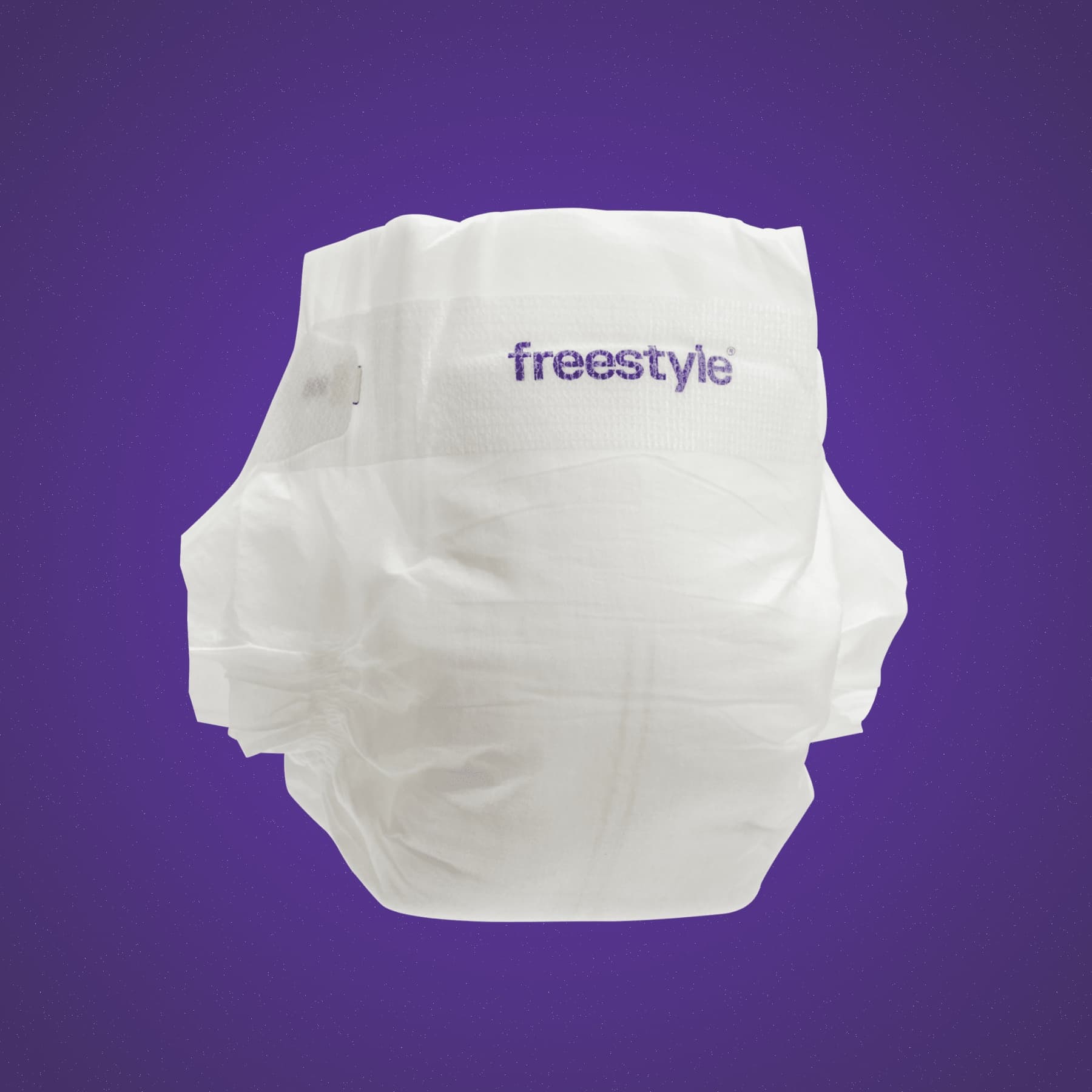 A Freestyle diaper against the brand’s purple background